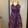 A purple satin halter dress with a floral organza overlay and matching sash.