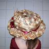 Wire framed, light weight 1900's derby hat.  The wire has been wraped in copper fabric prior to being covered by leaf printed chiffon.   Adorned with a satin ribbon, faux wheat straws and silk flowers.